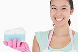 Smiling woman with a sponge