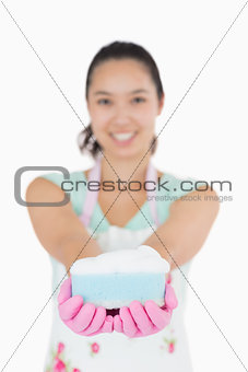 Woman holding a cleaning sponge