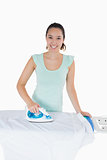 Smiling woman ironing
