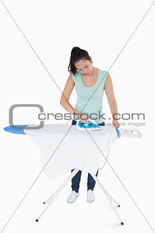 Brunette ironing shirts