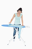 Smiling woman ironing blue jumper