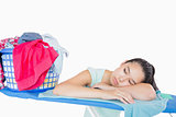Woman sleeping on an ironing board