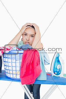 Woman getting frustrated from amount of ironing to do