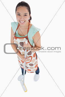 Happy woman sweeping the floor