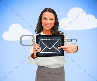 Businesswoman standing holding a tablet computer showing mail symbol