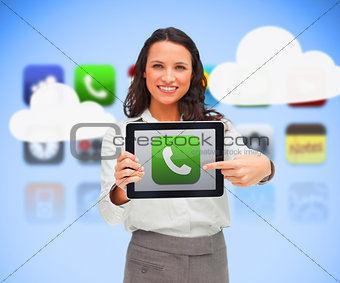 Businesswoman holding a tablet computer while smiling with phone symbol on screen