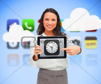 Businesswoman standing holding a tablet pc pointing to clock app symbol