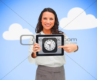 Woman standing while smiling holding a tablet pc