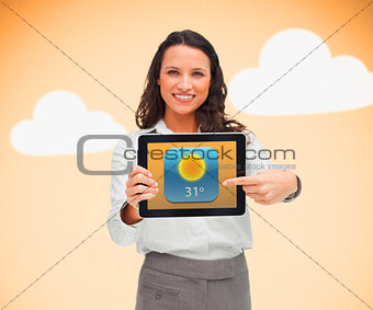 Businesswoman pointing to weather app symbol on tablet
