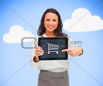 Businesswoman holding a tablet pc while smiling showing trolley symbol
