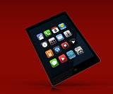 Tablet pc standing against red background