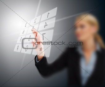 Businesswoman entering code on number pad hologram