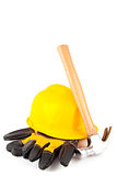 Hammer leaning against hard hat and builder's gloves
