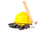 Claw hammer leaning against hard hat and builder's gloves