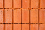Stack of clay bricks building a wall