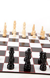 Black and white chess pieces standing at the chessboard