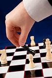 Hand holding black chessman