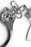 Handcuffs lying against white background