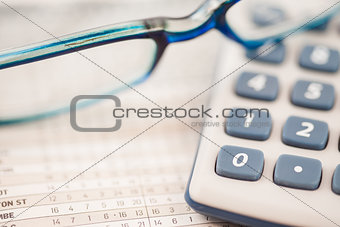 Close-up of glasses and calculator