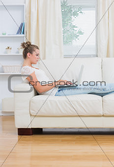Woman working on laptop in the living room