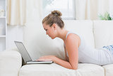 Woman using notebook while relaxing