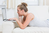 Joyful woman typing on the laptop