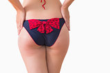 Woman at rear wearing bikini briefs