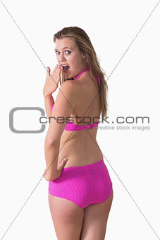 Woman wearing bikini while looking surprised