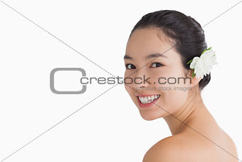 Black haired woman wearing a flower in her hair
