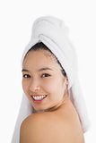 Black haired woman wearing a hair towel