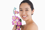 Smiling woman holding orchids