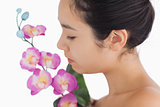 Woman smelling on orchids