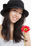 Smiling woman holding a flower