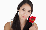 Smiling woman holding flower