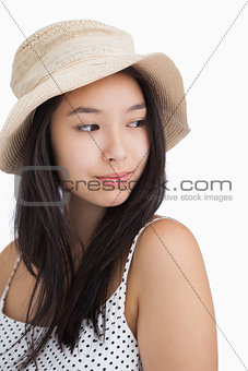Woman with a straw hat looking away