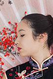 Serene woman wearing traditional Asian clothing