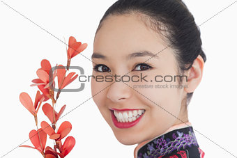 Woman in kimono smiling with flower