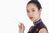 Woman in kimono holding chopsticks