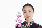 Woman holding an orchid while smiling