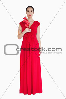 Woman in red evening gown with orchids