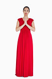 Woman in red dress with hands together