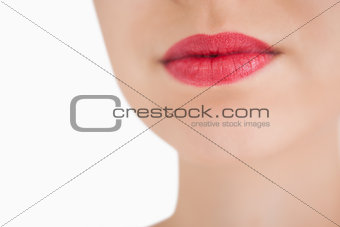 Woman wearing red lipstick against white background