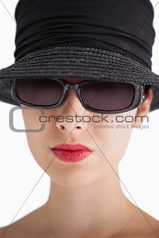 Woman wearing hat and sunglasses