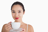 Woman smiling while holding a cup