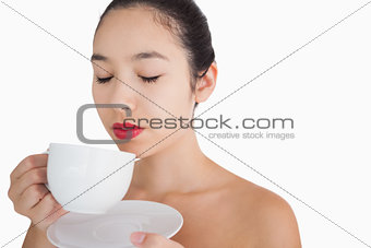 Woman smelling the coffee