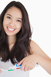 Woman smiling while holding a toothbrush