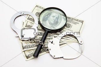 Magnifying glass money and handcuffs