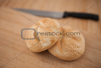 Buns and a knife lying on the background