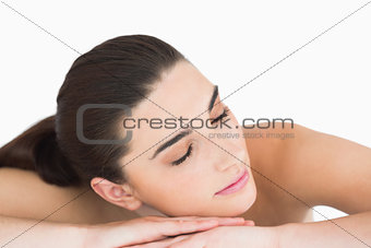 Woman leaning on her arms with her eyes closed