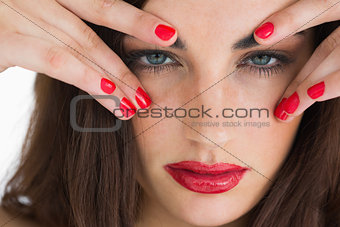 Brunette woman touching her eyebrows